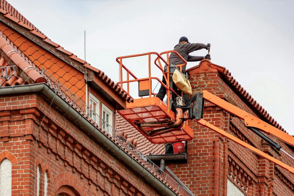 Real slate roofing tiles being meticulously installed on a historic Salt Lake City commercial building.