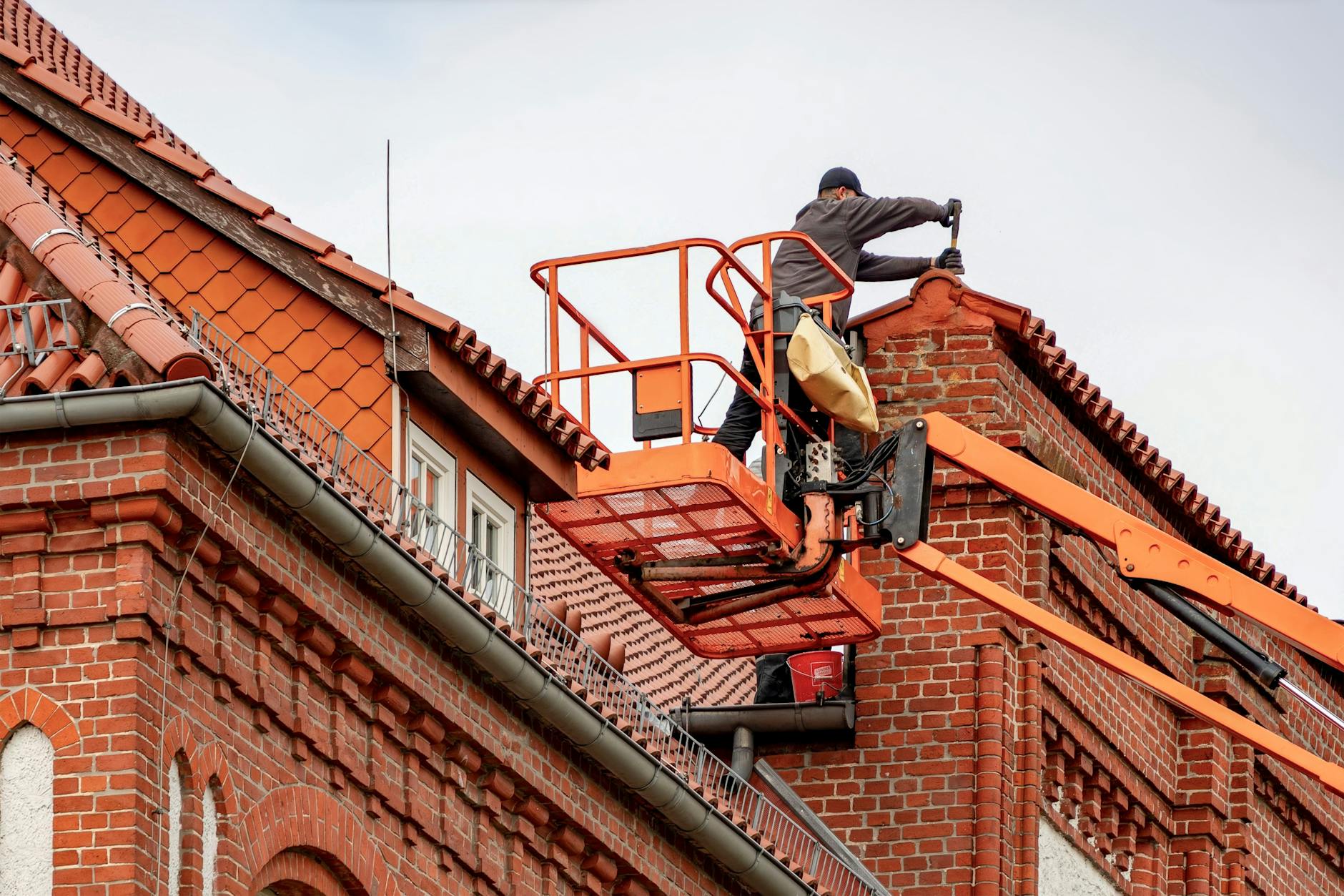 A professional roofing crew repairing a TPO membrane flat roof on a Salt Lake City commercial building under a bright sky.